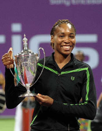 U.S. tennis player Venus Williams celebrates with her trophy after beating Russia&apos;s Vera Zvonareva in the final tennis match of the season-ending WTA Championships in Doha on Nov.10, 2008. Williams won 6-7 (5/7), 6-0, 6-2.