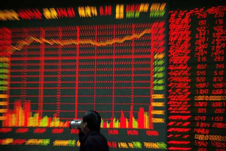 An investor drinks tea as he passes in front of an electronic board showing stock information at a brokerage house in the financial district of Beijing November 10, 2008. China&apos;s stock market surged to a two-week high and turnover expanded on Monday after the government announced a major stimulus package for the economy. [Agencies]