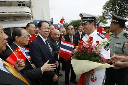 Fan Kuiju, captain of Chinese navy ship (CNS) Zhenghe, shakes hands with local Chinese at the Bangkok Port, Thailand, Nov. 10, 2008.
