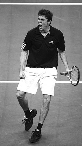 Gilles Simon of France reacts after beating Roger Federer of Switzerland in their group stage match at the Masters Cup in Shanghai yesterday. [Yang Shizhong/China Daily]