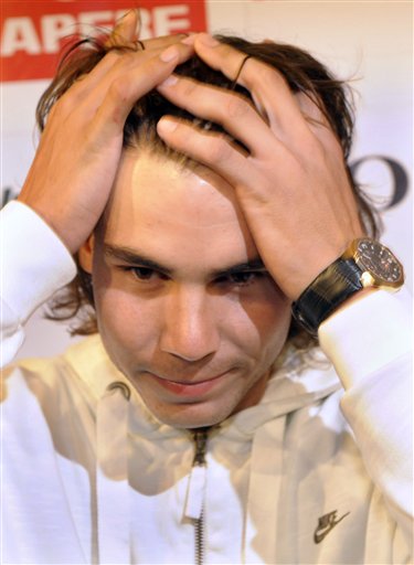 Spanish tennis player Rafael Nadal reacts during a press conference in Barcelona, Spain, yesterday. Rafael Nadal will miss Spain's Davis Cup final against Argentina because of a knee injury. The top-ranked Nadal said yesterday he's still struggling with tendinitis in his right knee.