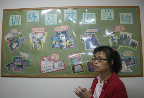 A-Jun, the director and trainer with the training centre for people with intellectual disabilities at the Fengyuan Street residential area in Guangzhou introduces the training lessons the centre offers on Monday, November 10th, 2008. 