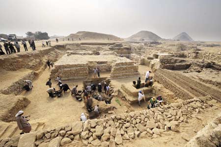 Workers clean fragments and dusts around the new found pyramid in Saqqara, 30Km south of Cairo, capital of Egypt, on Nov. 11, 2008. Hawass announced Tuesday that he and his team have discovered a new pyramid which dates back to 4300 years ago in Saqqara. He says it is belonged to Queen Sesheshet, the mother of King Teti who was the first king of the 6th Dynasty of Egypt's Old Kingdom, and becomes the 118th pyramid discovered so far in Egypt.