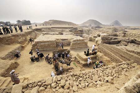 Workers clean fragments and dusts around the new found pyramid in Saqqara, 30Km south of Cairo, capital of Egypt, on Nov. 11, 2008. 