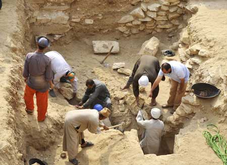 Workers clean fragments and dusts around the new found pyramid in Saqqara, 30Km south of Cairo, capital of Egypt, on Nov. 11, 2008. 