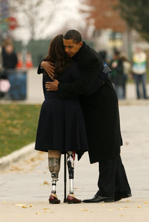U.S. President-elect Barack Obama hugs double-amputee Iraq war veteran Tammy Duckworth after they placed a wreath at a veterans memorial in Chicago Nov. 11, 2008. 
