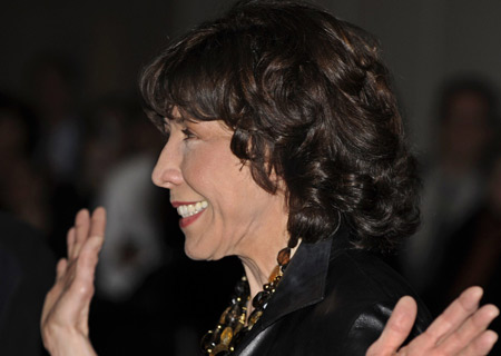 Actress Lily Tomlin poses for photographers as she arrives for the Kennedy Center's Mark Twain Prize for American Humor Gala