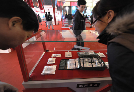 People visit the food sample that is produced for China's Shenzhou VII spacecraft during an exhibition featuring the Shenzhou VII manned space flight at the Military Museum of the Chinese People's Revolution in Beijing, capital of China, Nov. 11, 2008.