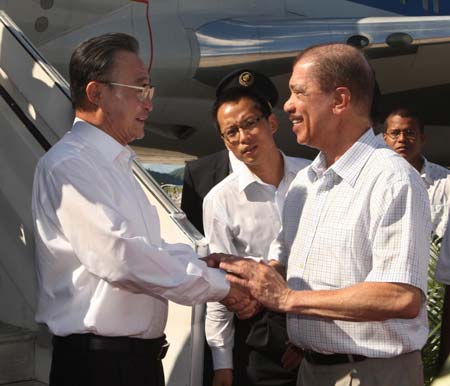 Wu Bangguo (L), chairman of the Standing Committee of China's National People's Congress(NPC), the country's top legislature, is greeted by James Alix Michel, president of the Republic of Seychelles, upon his arrival in Victoria, capital of the Indian Ocean archipelago, Nov. 12, 2008.