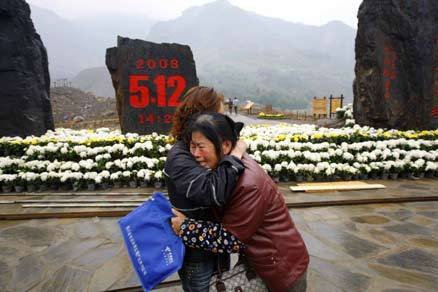 A distraught mother and daughter console each other in front of a monument at a country's first earthquake relic park in Qingchuan, Sichuan province, November 11, 2008. The park officially opened on November 12, 2008. [Wang Xiwei] 