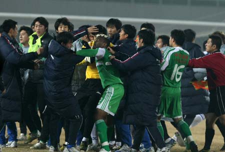 Players of Beijing Guo'an and Tianjin Kangshifu of Chinese Super League scuffle after Beijing's defender Zhang Yonghai picked up a controversial second yellow card that sent him off during the last minutes of the game in Beijing November 12, 2008. 