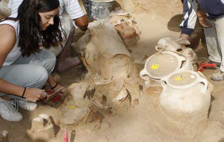 Archaeologists work on earthenware potteries found at an excavation site in the port city of Tyre, southern Lebanon Nov. 12, 2008. 