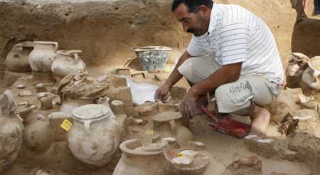 A worker unearths Phoenician potteries found at an excavation site in the port city of Tyre, southern Lebanon November 12, 2008.