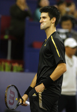 Serbia's Novak Djokovic reacts after losing a point to French player Jo-Wilfried Tsonga during the men's singles competition at Tennis Masters Cup Shanghai, 2008, in Shanghai, east China, Nov. 13, 2008. 