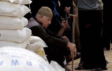 A Palestinian refugee waits to receive food at a United Nations food distribution center in the Beach refugee camp in Gaza City Nov. 12, 2008. The U.N. Relief and Works Agency (UNRWA) said on Wednesday that it would run out of food within 48 hours as the blockade imposed on Gaza by Israel continues. [Xinhua]