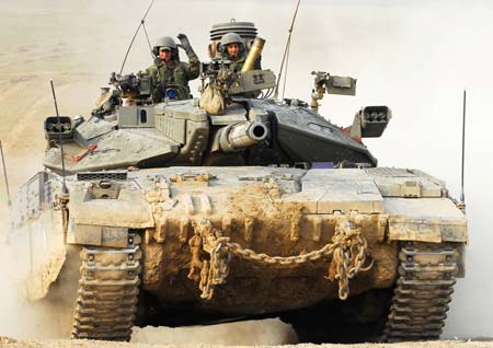 An Israeli tank runs on the Israel Gaza border, Nov. 12, 2008. The Israel Defense Forces (IDF) soldiers exchanged fire with Palestinian militants near the border of Gaza Strip earlier Tuesday, killing four Palestinian militants.