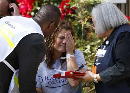 A simulated earthquake victim is consoled by a Chaplain at an outdoor triage center during an earthquake drill at the University California San Diego Medial Center in San Diego, California November 13, 2008.