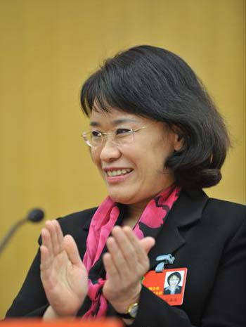 Zhang Haidi, the new chairperson of the China Disabled Persons' Federation (CDPF), applauds during the closing session of the fifth national congress of the CDPF in Beijing, November 13, 2008.