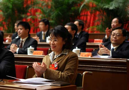 Zhang Haidi applauds at a session of the fifth national congress of the China Disabled Persons' Federation (CDPF) in Beijing, November 11, 2008. Zhang was elected as new chairperson of the CDPF on Thursday's session and former chairperson Deng Pufang would serve as the CDPF's honorable chairman. Writer and translator Zhang has long been known as a national role model for her tenacity. [Xinhua]