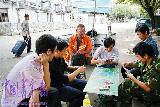 Several laid off workers are seen playing cards to kill their leisure time. They are waiting for the compensation which they could hopefully get through arbitration.