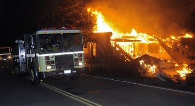 A mansion burns during a wildfire, Friday, Nov. 14, 2008, in Santa Barbara, Calif. An official in Santa Barbara County, says the fire has destroyed about 70 homes in the upscale community of Montecito.