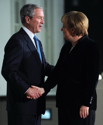 US President George W. Bush (L) greets German Chancellor Angela Merkel upon arrival at the North Portico of the White House before a dinner for the participants in the G-20 Summit on Financial Markets and the World Economy in Washington November 14, 2008. 