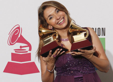 Brazilian gospel singer Soraya Moraes smiles with the two awards she won, backstage at the 9th annual Latin Grammy Awards in Houston, Texas November 13, 2008.