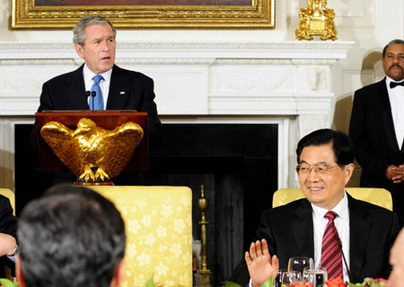 Chinese President Hu Jintao (R) smiles as U.S. President George W. Bush (L) speaks at a reception dinner hosted by Bush for the leaders attending the Summit on Financial Markets and the World Economy in Washington, U.S., Nov. 14, 2008.