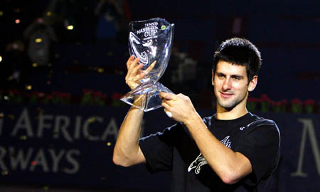 Serbia's Novak Djokovic celebrates with his trophy during the awarding ceremony for the final of men's singles at Tennis Masters Cup Shanghai, 2008, in Shanghai, Nov. 16, 2008. Novak Djokovic won the title by defeating Russia's Nikolay Davydenko 6-1, 7-5. [Xinhua]