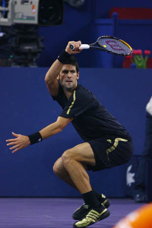 Serbia's Novak Djokovic acts against Russia's Nikolay Davydenko during the final of men's singles at Tennis Masters Cup Shanghai, 2008, in Shanghai, Nov. 16, 2008. Novak Djokovic won the title by defeating Davydenko 6-1, 7-5. [Xinhua]