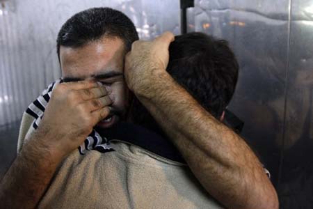 A Palestinian man mourns the loss of a relative killed in an Israeli air strike at the mortuary of a hospital in Gaza City. Outgoing Israeli Prime Minister Ehud Olmert has accused the Islamist Hamas movement of 'shattering' the truce in Gaza and said he had ordered security chiefs to draw up plans to end its rule.