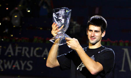 Serbia's Novak Djokovic celebrates with his trophy during the awarding ceremony for the final of men's singles at Tennis Masters Cup Shanghai, 2008, in Shanghai, Nov. 16, 2008. Novak Djokovic won the title by defeating Russia's Nikolay Davydenko 6-1, 7-5. (Xinhua/Fan Jun)