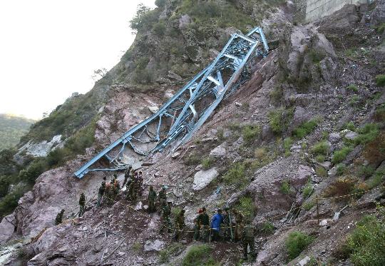 Indian soldiers hunt for accident survivors around the collapsed bridge. The bridge under construction over an Himalayan river in Indian-controlled Kashmir collapsed Sunday, killing at least four workers and leaving 19 others missing and feared dead, local police said.