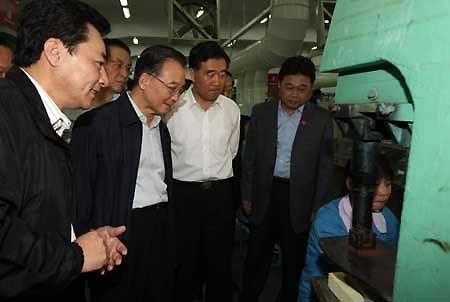 Chinese Premier Wen Jiabao (2nd L) inspects a medium-sized enterprise in Dongguan of south China's Guangdong Province, November 14, 2008.