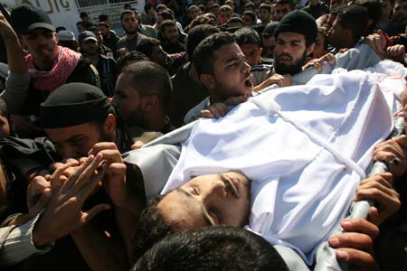 Palestinians carry the body of Ahmed al-Hellou, a militant of the Popular Resistance Committees (PRC), during a funeral in Gaza, on Nov. 16, 2008. An Israeli attack left four Palestinian militants dead in the eastern Gaza Strip on Sunday. 