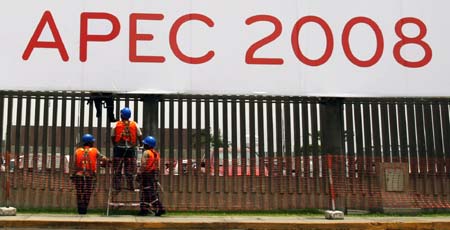  Staff members work on an advertising board of the Economic Leaders' Informal Meeting of the Asia-Pacific Economic Cooperation (APEC), in Lima, capital of Peru, Nov. 14, 2008. The 16th APEC Economic Leaders' Informal Meeting is scheduled to be held Nov. 22-23 in the Peruvian capital of Lima. 