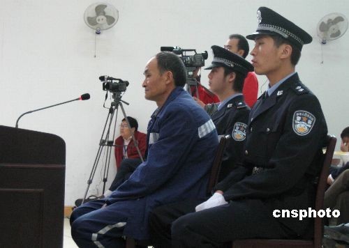 Zhou Zhenglong, who was accused and found guilty of faking photographs of a critically-endangered tiger species in the wild, stands second trial Monday, Nov 17, 2008 in northwest China's Shaanxi Province. 