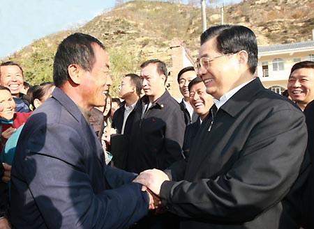 Undated photo shows General Secretary of the Communist Party of China (CPC) Central Committee Hu Jintao (R), who is also Chinese President and Chairman of the Central Military Commission, chats with a villager during his visit to Hougoumen Village of Yanhewan Town in Ansai County of Yan'an City, northwest China's Shaanxi Province. Leaders of the CPC have visited nine places in the country to find out how well the Party members, officials and common citizens were learning and implementing Scientific Outlook on Development. It is considered an important guiding principle for China's economic and social development. 