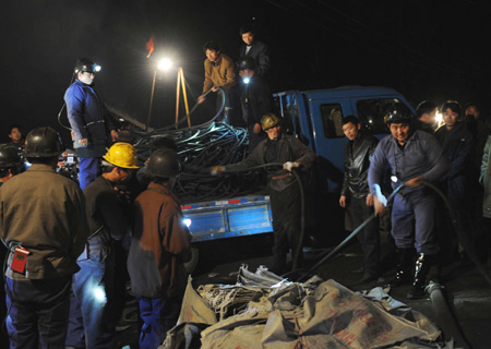 Rescuers prepare to work at the site of the flooded coal mine in Jiaxian County, Pingdingshan City of central China's Henan Province, on Nov. 17, 2008. Gaomendong Coal Mine flooded on Monday at about 7:30 a.m. in Jiaxian County of Henan Province. There were 42 people working underground when the mine shaft flooded.