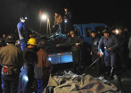 Rescuers race against time to search and rescue miners trapped in a flooded Gaomendong coal mineons, Pingdingshan City, Central China's Henan Province, November 17, 2008. 34 people were trapped in this coal mine that flooded early Monday morning. 