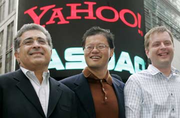 Yahoo! co-founders Jerry Yang (C) and David Filo (R) pose with chief executive Terry Semel in front of the NASDAQ MarketSite in Times Square in New York after ringing the opening bell at NASDAQ in this March 2, 2005 file photo.