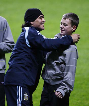 Argentina's soccer team head coach Diego Maradona embraces Celtic Park stadium ball boy Adam Brown after he found a necklace Maradona lost during a training session at Celtic Park stadium in Glasgow, Scotland November 17, 2008. Argentina play Scotland in an international friendly soccer match at Hampden Park stadium on Wednesday.