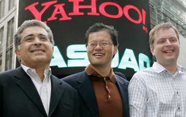 Yahoo! co-founders Jerry Yang (C) and David Filo (R) pose with chief executive Terry Semel in front of the NASDAQ MarketSite in Times Square in New York after ringing the opening bell at NASDAQ in this March 2, 2005 file photo. Following investor pressure for a management CEO Semel is stepping aside and will be replaced as CEO by Yang, Yahoo said on June 18, 2007.