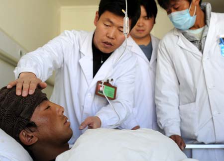 A wounded passenger is treated at the People's Hospital in Lhasa, capital of southwest China's Tibet Autonomous Region November 18, 2008. A passenger bus plunged into a valley last Friday in Nagqu prefecture, leaving 18 dead and 29 injured. The wounded have been sent to major hospitals in Lhasa and police are investigating the cause of the crash.