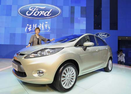 Designer Chelsia Lau poses with the new Ford Fiesta four door at the 6th Guangzhou International Automobile Exhibition in the southern Chinese city of Guangzhou November 18, 2008.