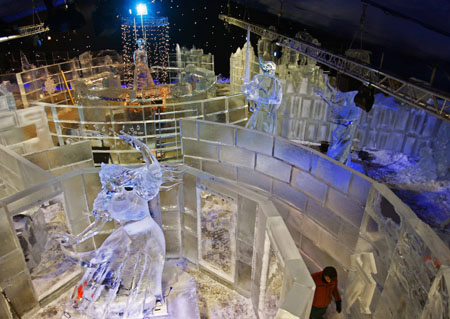 A man walks past sculptures made out of a large chunk of ice at the Snow and Ice Sculpture Festival in Bruges November 18, 2008. The festival opens on November 21 and ends on January 11, 2009. 