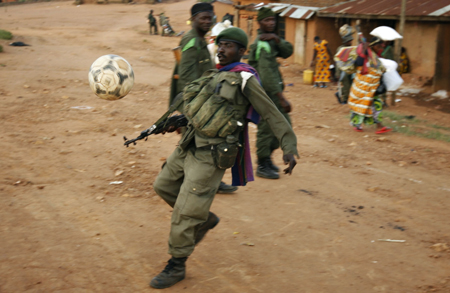 A government kicks a football after a day of fighting in the village of Kayna in eastern Congo, Nov.18, 2008. 