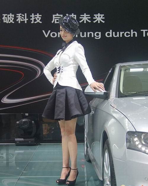 A model stands next to a car at the 6th Guangzhou International Automobile Exhibition in Guangzhou, South China's Guangdong Province, November 18, 2008.