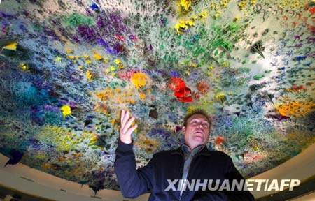 Spanish artist Miquel Barcelo stands under his ceiling painting on the dome of Room XX at the European headquarters of the United Nations in Geneva, Nov. 17.