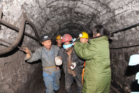 A miner with a blindfold over his eyes to protect him from the light is rescued from a flooded coal shaft in Henan Province early Tuesday November 18 2008. Rescuers pulled 32 miners out of the Gaomengdong mine in Pingdingshan. Two others died. [Xinhua] 